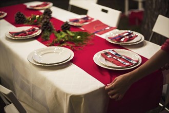 Hands fixing red table runner dinner