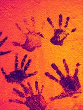 Color background of children's handprints. Multi colored hand prints