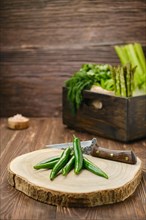 Fresh green cilli pepper on wooden cutting board