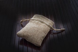 Empty little sack made of linen on canvas background