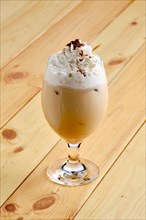 Cold raf coffee in transparent glass on wooden background