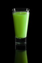 Glass of kiwi and celery cocktail isolated on black