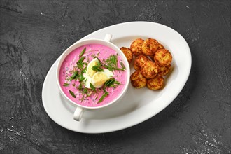 Overhead view of cold beetroot soup with potato balls