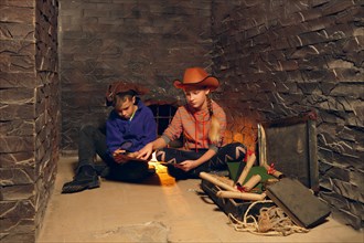 Two children in quest game solving a puzzle. Pirates treasure chest