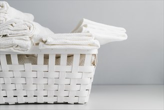 Front view white basket with towels