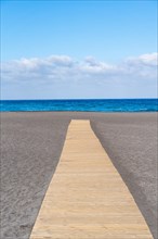 Wooden plank path on the beach of the capital Santa Cruz