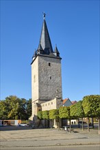 City wall at the Johannistorturm with the bronze figure of the polymath Adam Olearius by sculptor Bernd Goebel