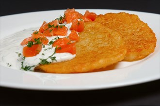 Traditional belorussian potato pancakes with salmon and sour cream