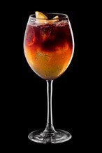 Espresso and tonic cocktail in wine glass isolated on black background