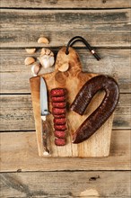 Top view of smoked dried beef sausage on wooden cutting board