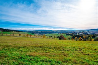 A meadow at the foot of the Fichtelberg with a view into the valley in autumn
