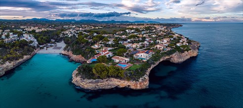 Sunset over Cala Anguila-Cala Mendia from a drone
