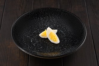 Half of boiled egg cut on two pieces on a plate