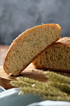 Macro photo of homemade wheat bread on wooden cutting board