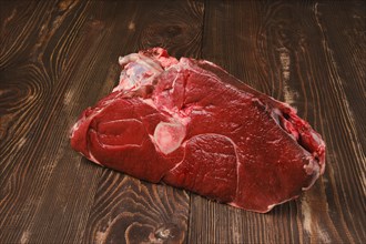 Raw fresh beef shank cross-cut on wooden background