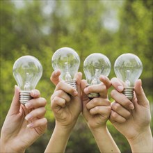 Hands holding light bulbs