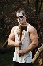 Male daemon with axe near firewood placing. Face painting art