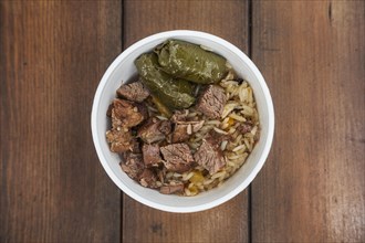 Soft focus photo of dolma and fried meat in take away plate
