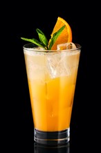 Cold fizz cocktail with orange isolated on black background