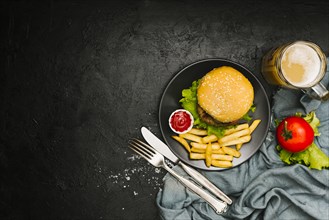 Flat lay burger and fries on plate with copyspace