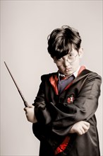 Boy with glasses in Harry Potter costume