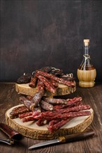 Different kinds of sausages on wooden background