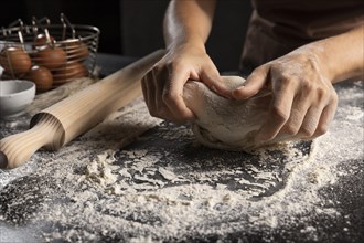 Chef kneading dough flour table