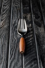 Soft focus photo of stylish fork with wooden handle