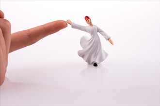 Hand holding a Sufi Dervis on a white background