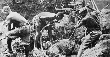 Native Cameroonian workers with modern tools