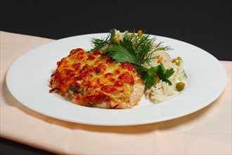 Plate with baked chopped chicken fillet with cheese and rice