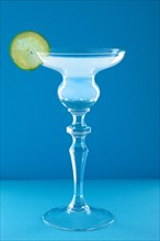 Gin tonic cocktail on blue background