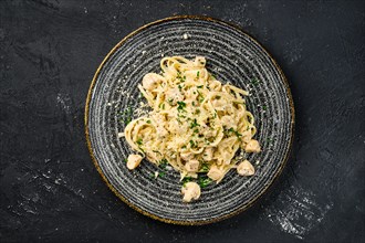 Overhead view of pasta with mushrooms and chicken