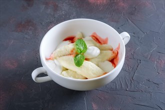 Lazy dumplings with sour cream and strawberry jam