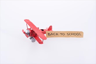 Little model plane carriying a back to school banner