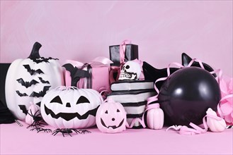 Modern pink Halloween decor with black and white pumpkins