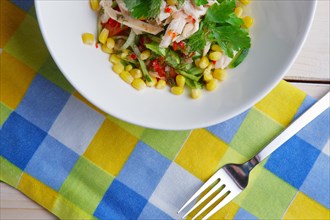 Top view of part of table with salad with corn