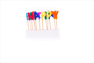 Color candles on sticks write the word happy
