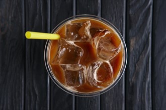 Top view of ice coffee drink with straw