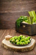 Fresh Brussels sprouts on wooden cutting board