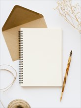 White notebook with wooden nib pale brown envelope with brown thread branch white background. Resolution and high quality beautiful photo