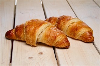 A pair of fresh croissant on the table