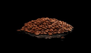 Roasted coffee beans scattered on dark glossy surface