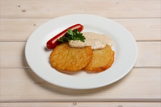 Portion of potato frlapjack with smoked sausage and mustard sauce