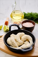 Prepared for frying uncooked shrimps in cheese breading with spice