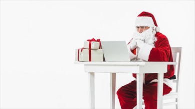 Santa claus looking laptop screen