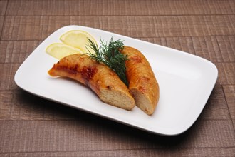 Plate with fish sausage and lemon