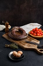 Blood sausage rolled on wooden cutting board