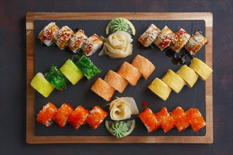 Top view of big set of rolls served on stone plate