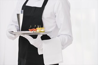 Servant uniform holding tray. Resolution and high quality beautiful photo